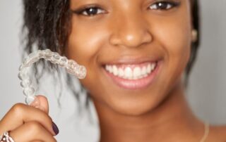 A young Long Island woman uses Invisalign braces